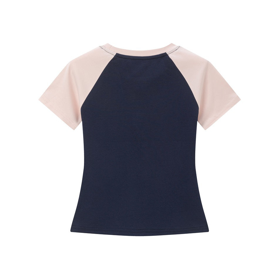 Back view of a navy short-sleeve raglan T-shirt with pale pink sleeves and neckline.