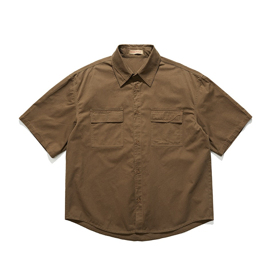 Brown short-sleeve button-up shirt with two flap chest pockets, flat lay front view