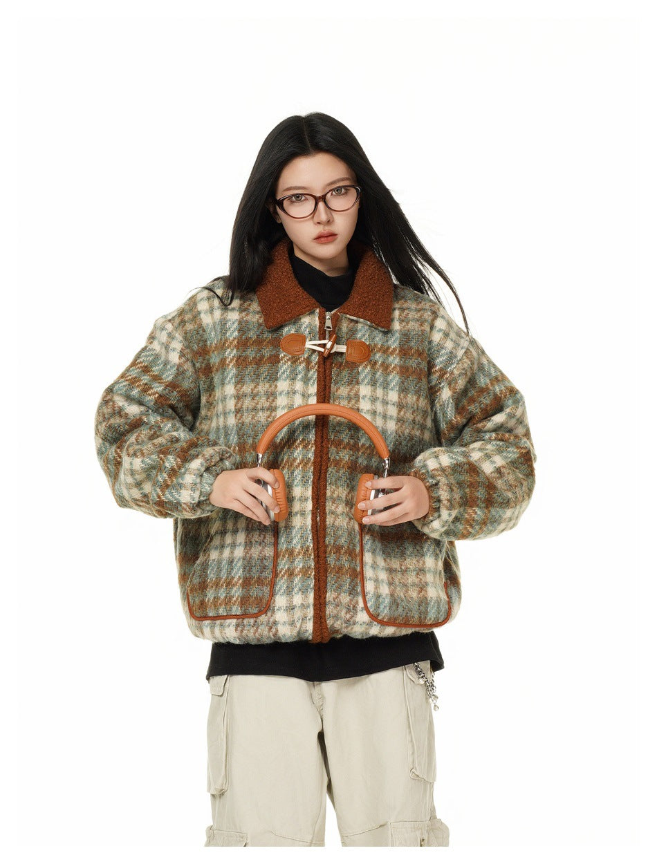 Model wearing the plaid jacket with toggle closure and piped pockets, holding orange headphones in front of the chest