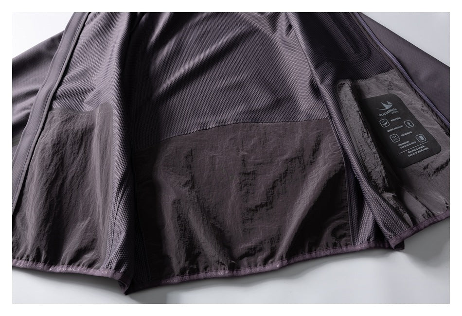 The jacket is opened to show its mesh upper lining, smooth lower lining, and interior tag.