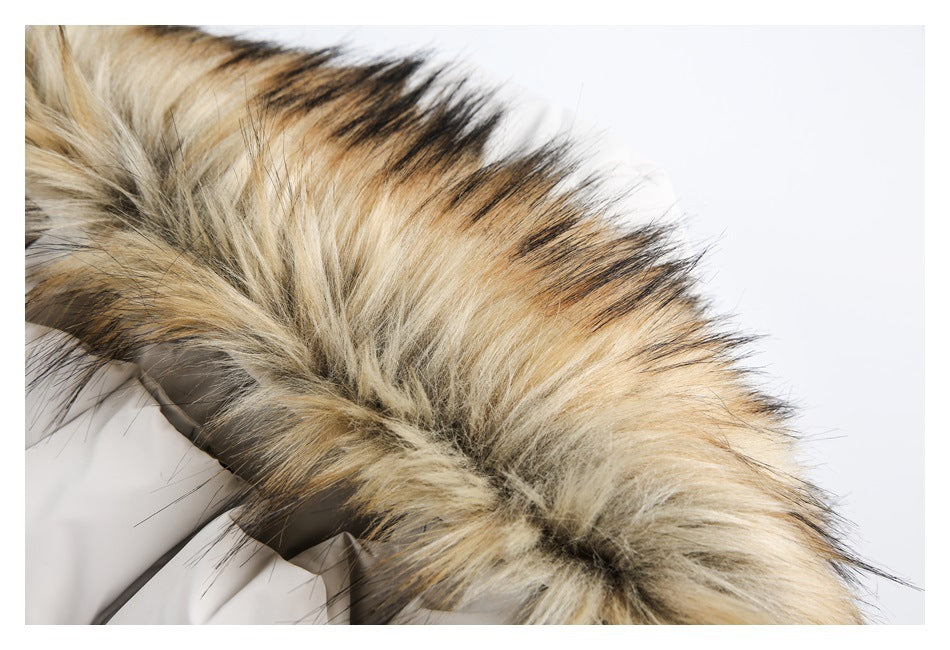 Close-up of a tan, cream, and black faux-fur trim on a light beige coat.
