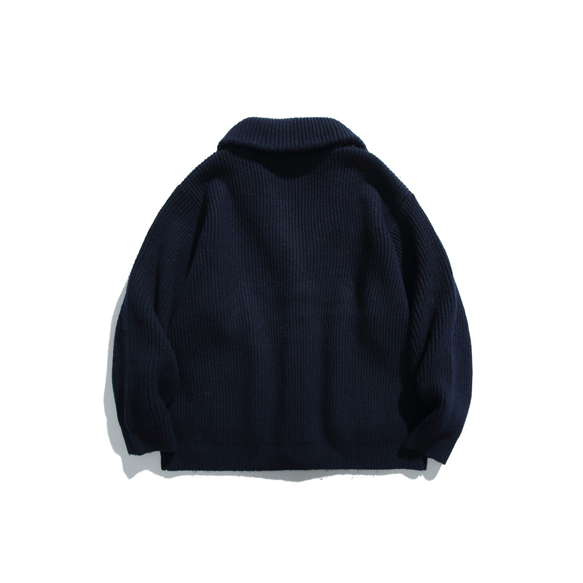 Back view of a navy ribbed cardigan with a shawl collar and long sleeves.