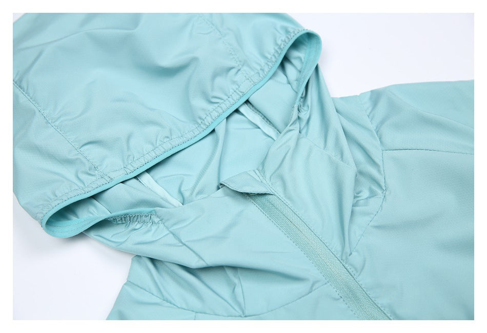 Close-up of the light aqua jacket's hood opening, gathered edge, and neckline zipper.