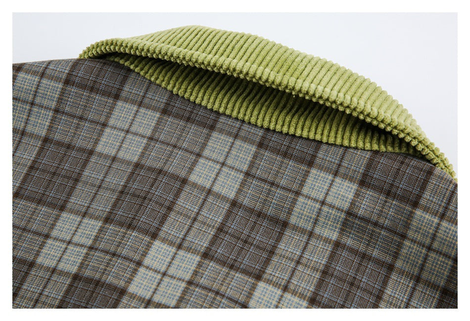 Close-up of a brown and muted blue plaid garment with a light olive ribbed collar.