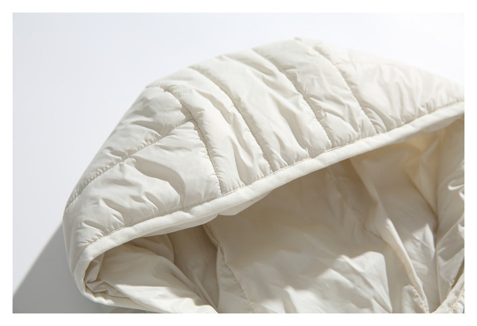 Close-up of the ivory jacket's quilted hood, showing the bound edge and hood lining.
