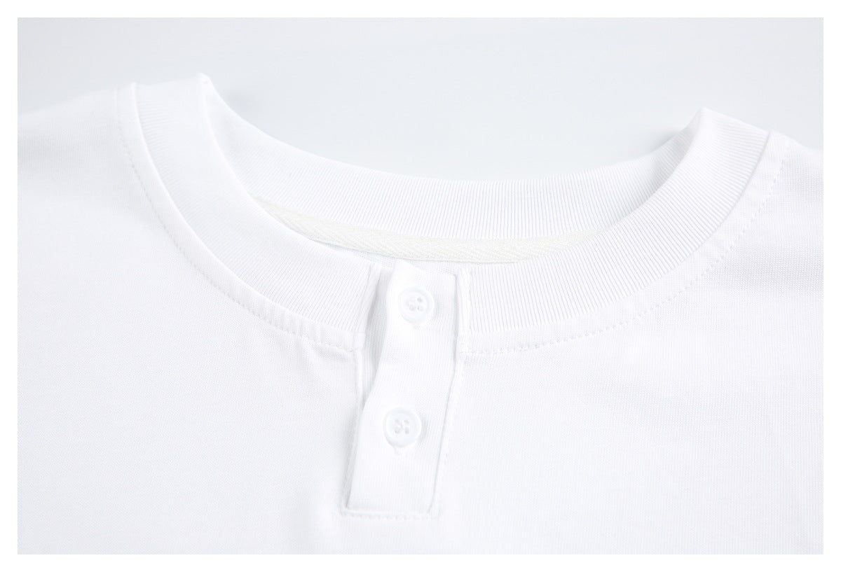 Close-up of a white shirt's ribbed crew neckline and two-button placket.