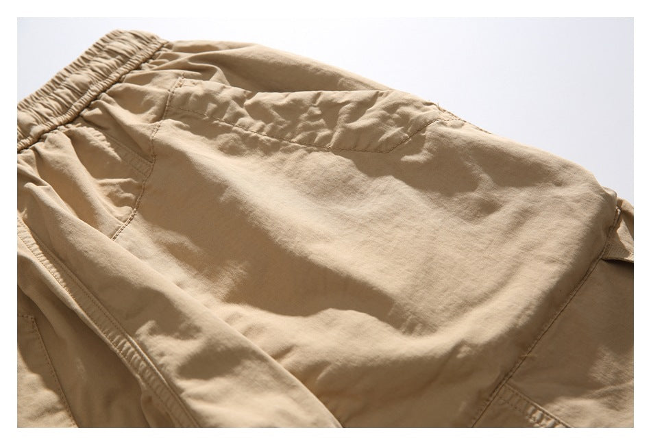 Close-up of a tan shorts panel with curved seams and visible stitching.
