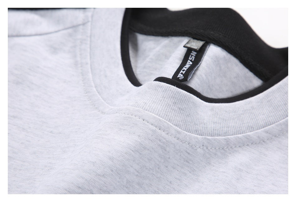 Close-up of a light gray heathered shirt neckline with ribbed collar and black inner neck label.