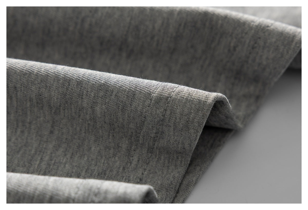 Close-up of heather gray knit fabric draped to show its texture and folded edge.
