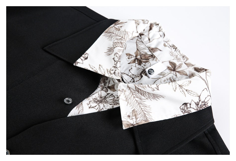 Close-up of a black garment with a white brown-floral collar and matching inner facing.