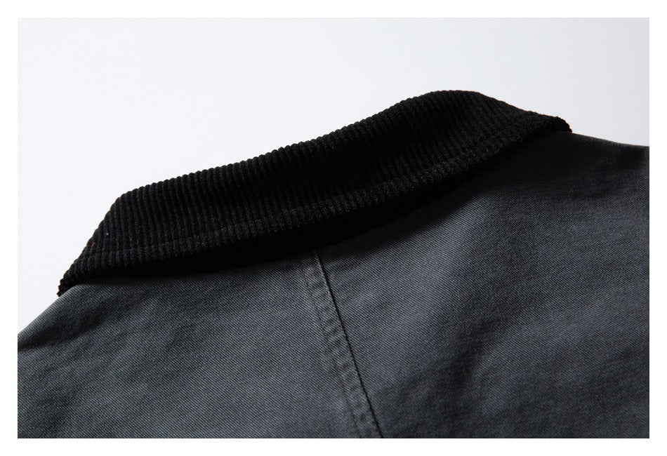 Close-up of a black ribbed collar on a dark charcoal garment.