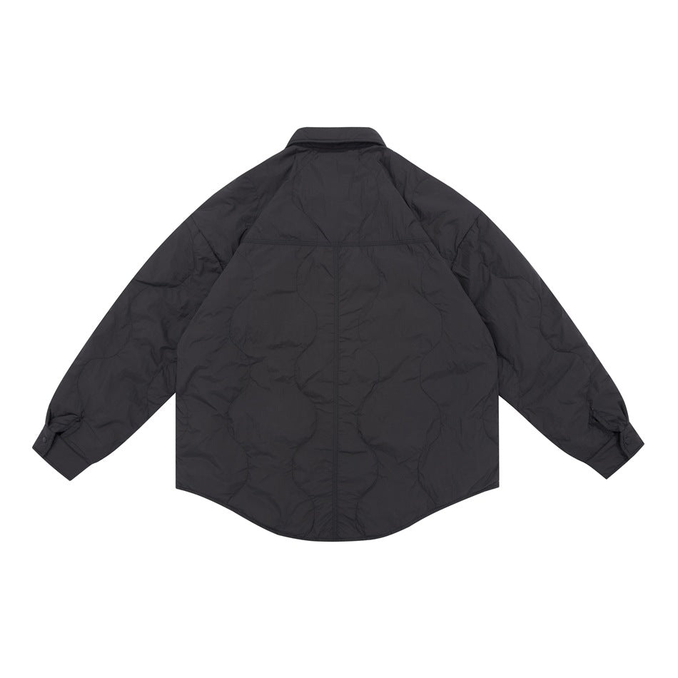 Back view of a black quilted shirt jacket with long sleeves and a rounded hem.