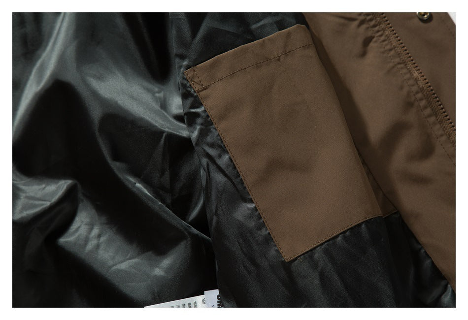 Close-up of a brown rectangular pocket panel sewn onto the jacket's black lining.