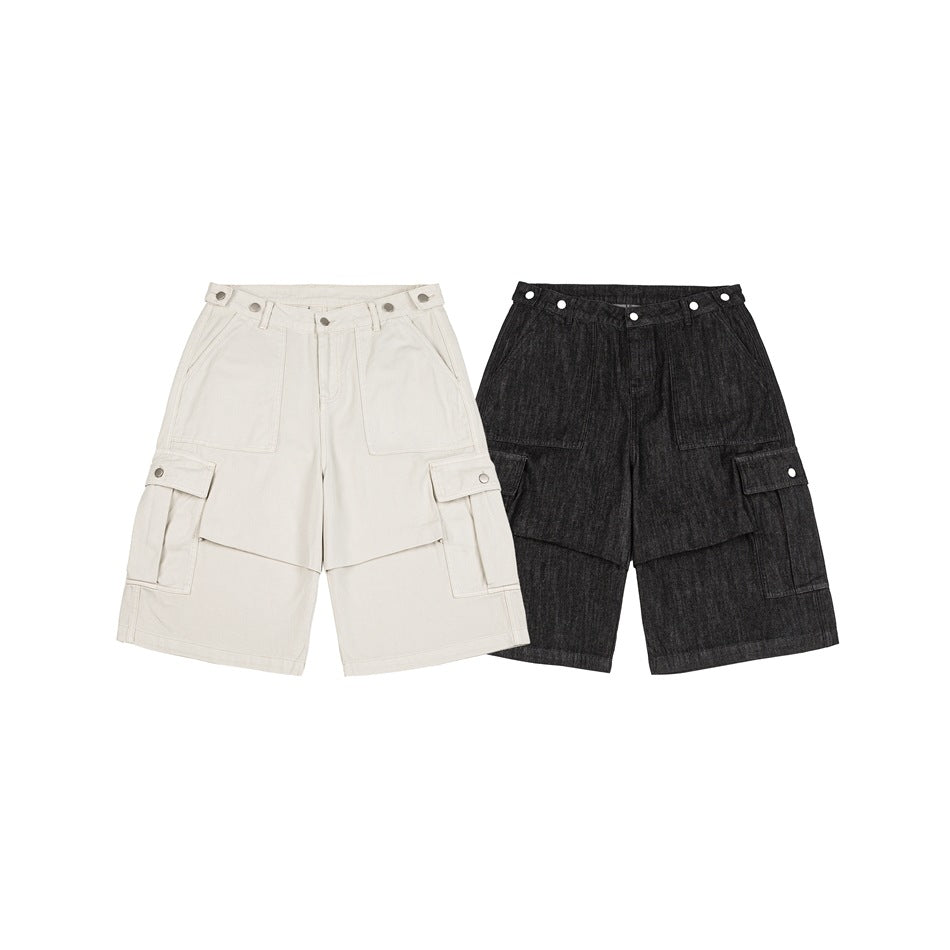 Front view of wide-leg cargo shorts in off-white and charcoal, with snap details and large side pockets.