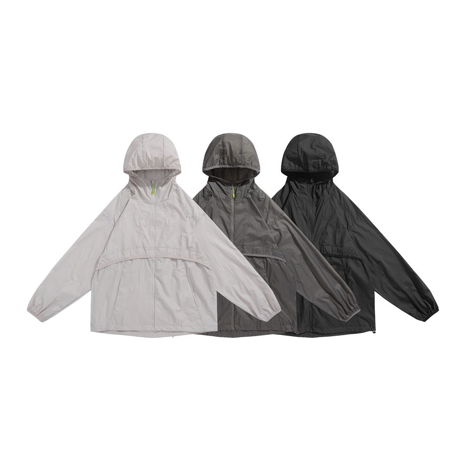 Three hooded zip jackets displayed together in light beige, charcoal gray, and black.