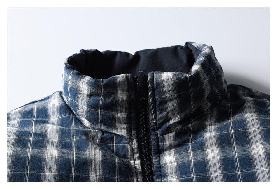Close-up of a blue-gray plaid jacket's high collar and front zipper.