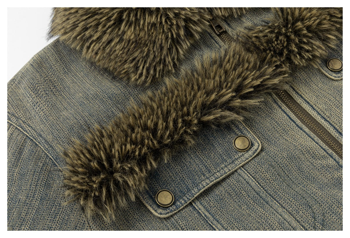 Close-up of a blue-gray textured jacket with brown faux-fur trim, brass-tone snaps and a zipper.