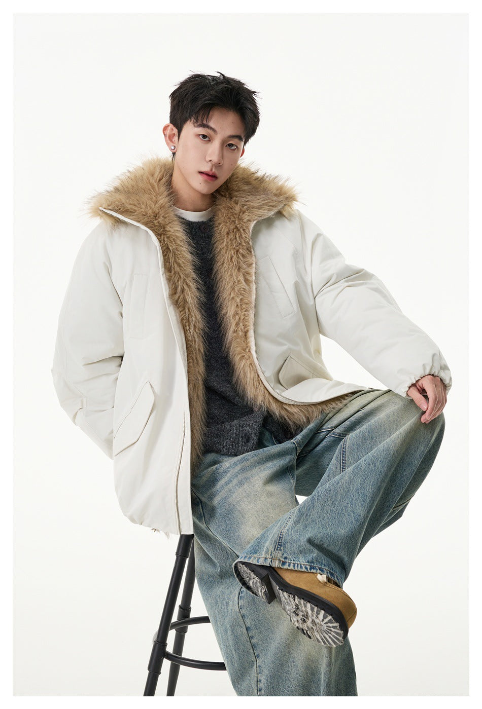 Model wearing an open ivory jacket with a wide tan faux-fur collar and oversized pockets.