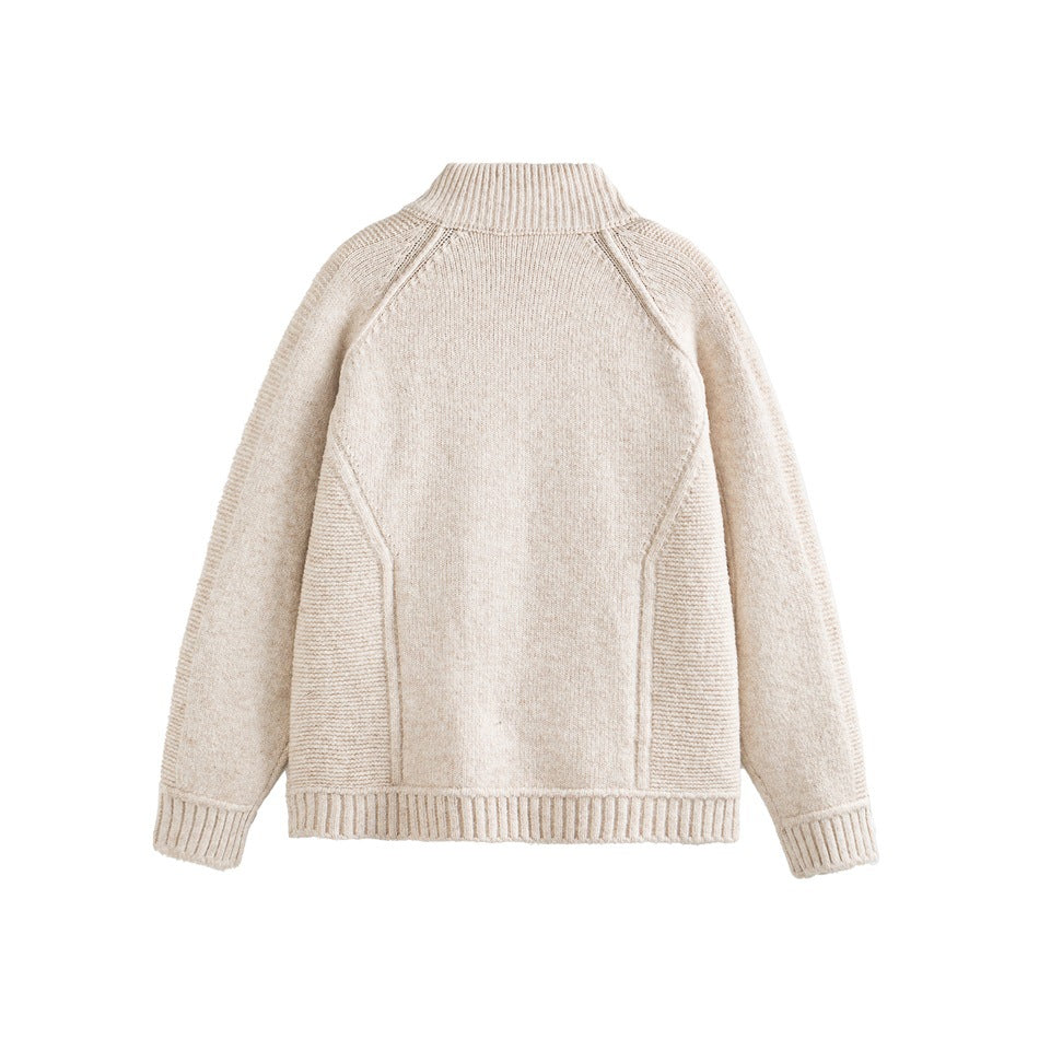 Back view of a cream high-neck knit sweater with raglan sleeves and ribbed cuffs and hem on white.