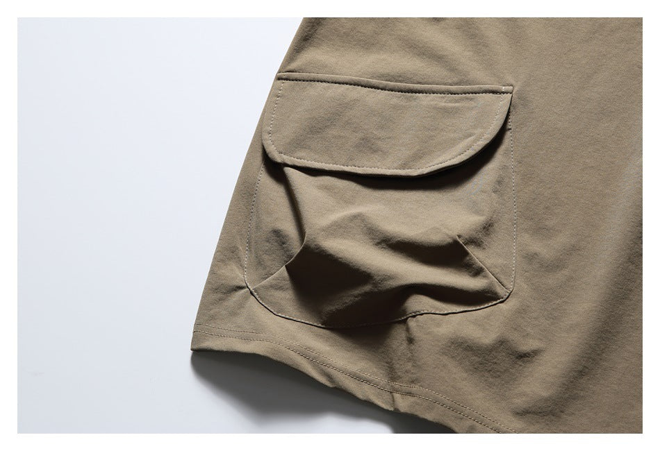 Close-up of one large flap pocket on the taupe top.