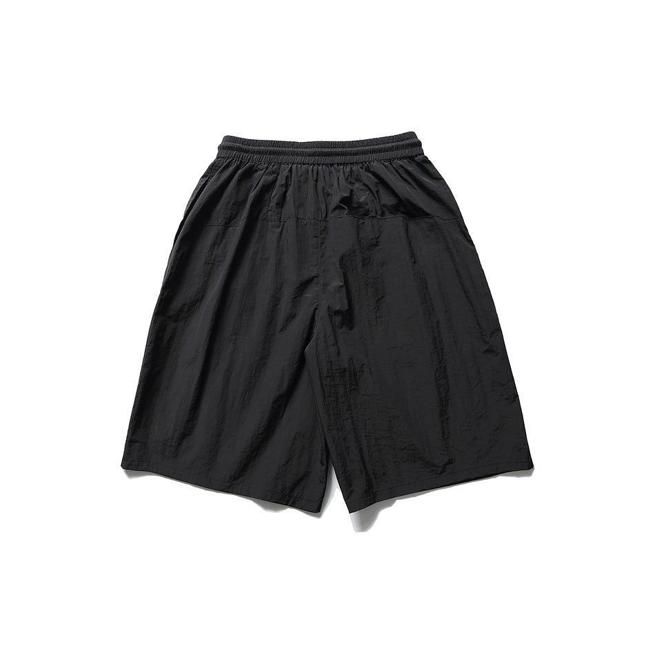Black knee-length shorts back view with elastic waistband and back yoke seam