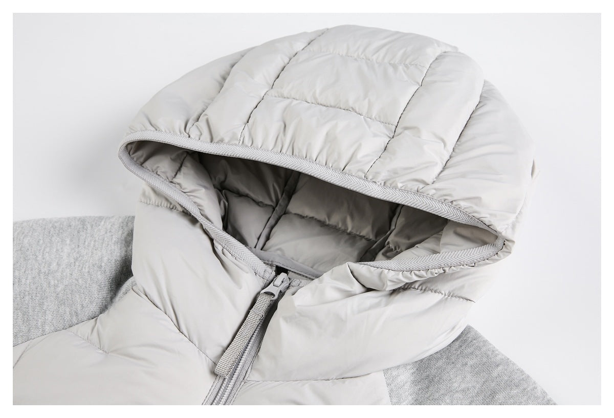 Close-up of a light gray jacket's padded hood, lining, trim, and upper zipper.