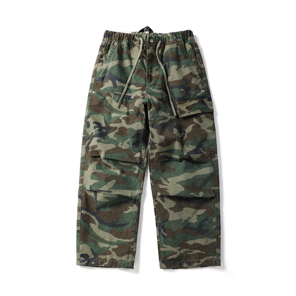 Green camouflage wide-leg cargo pants with drawstring elastic waist, side cargo pocket and knee pleats, flat lay front view