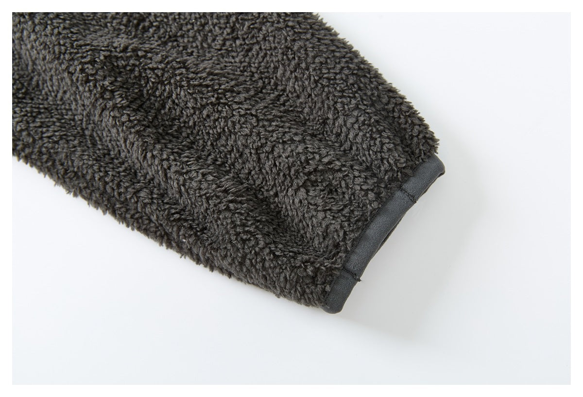 Close-up of a charcoal fleece jacket sleeve ending in a dark gray fabric cuff.