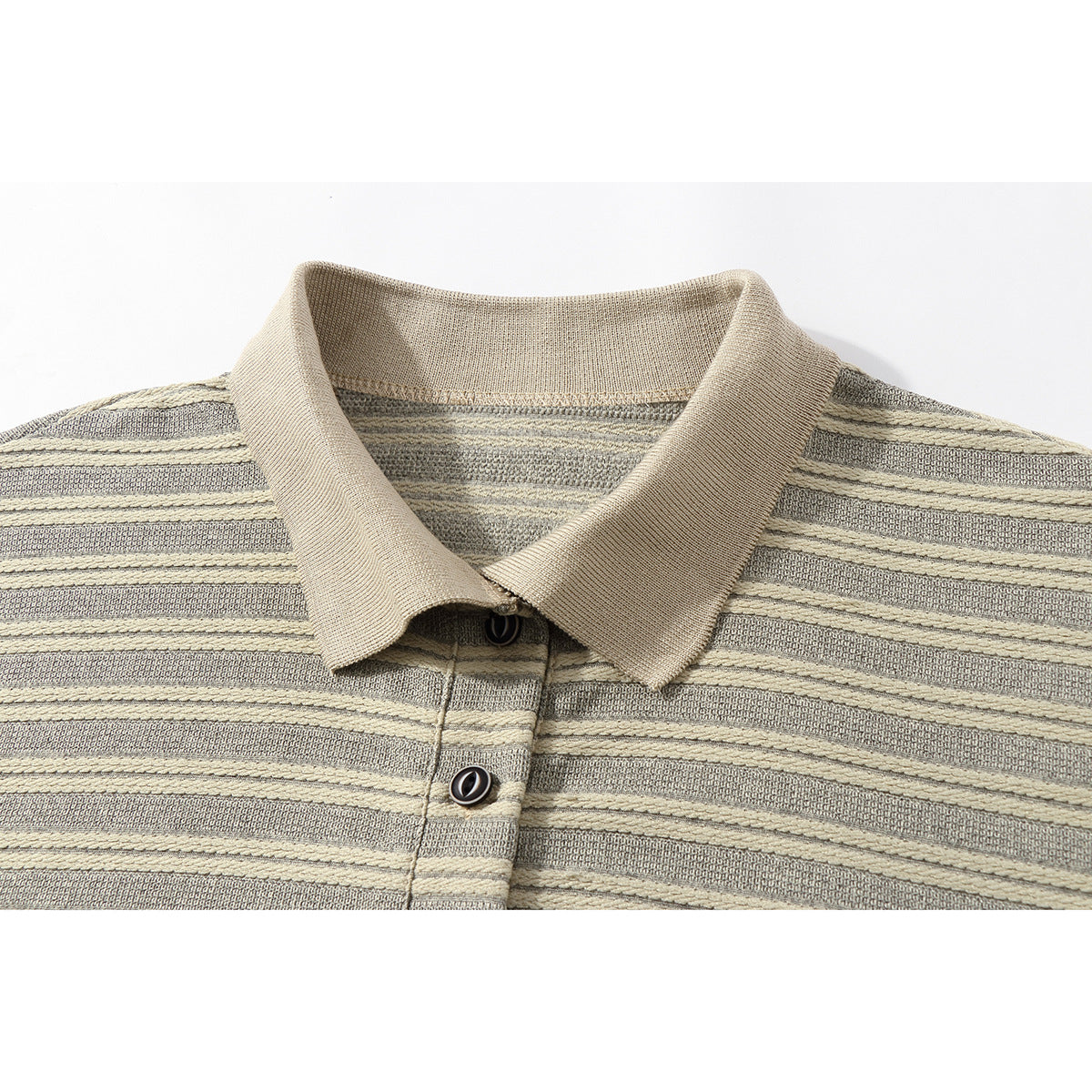 Close-up of a beige-collared shirt with gray and cream horizontal stripes and dark buttons.