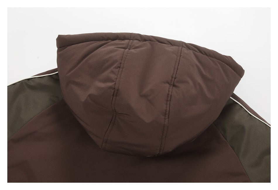 Close-up of a brown jacket hood with stitched panels, olive lining, and light piping.