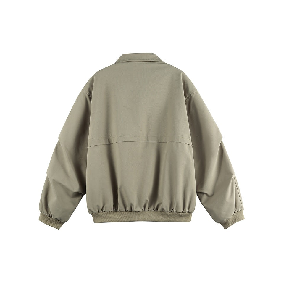 Back view of sage green jacket showing horizontal yoke seam, ribbed cuffs and hem, and collar, flat lay