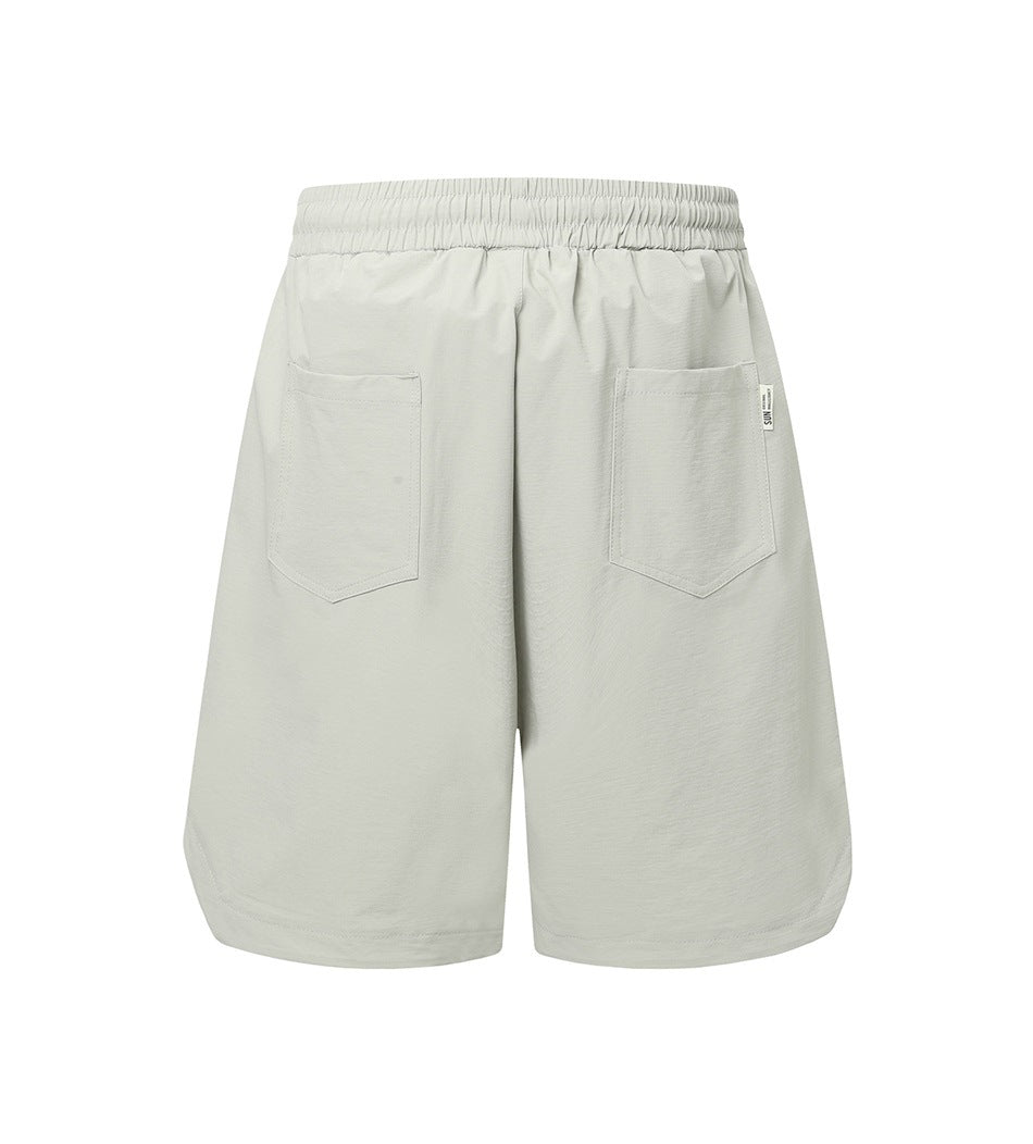Light gray knee-length shorts shown from the back, with an elastic waistband and two patch pockets.