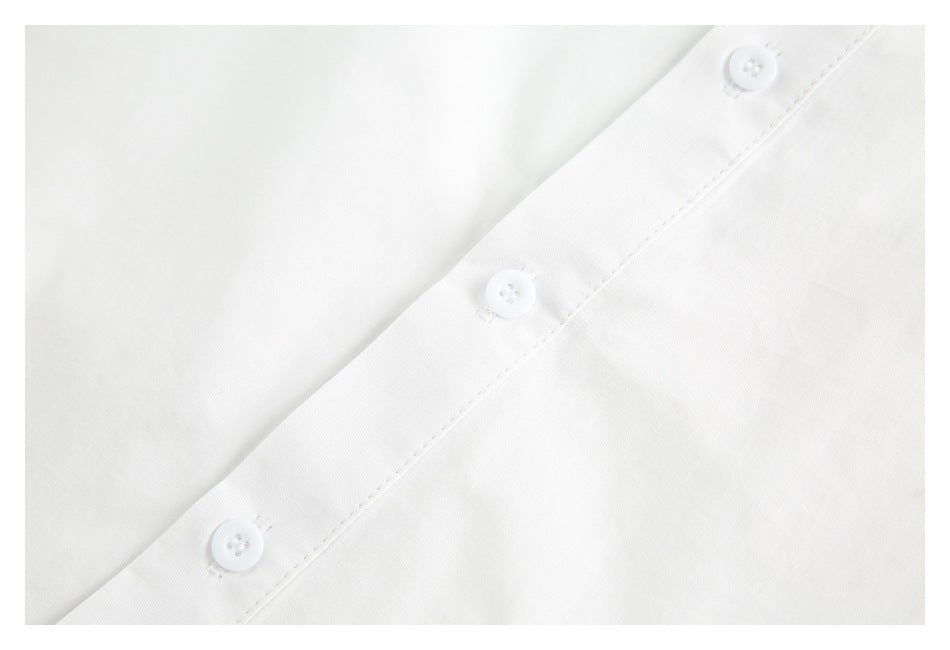 Close-up of a white shirt's button placket with three white buttons.