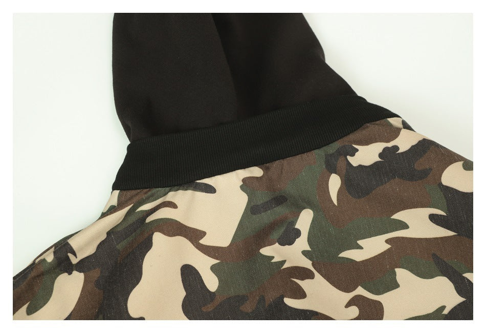Close-up of a black ribbed neckline and hood against a camouflage garment body.