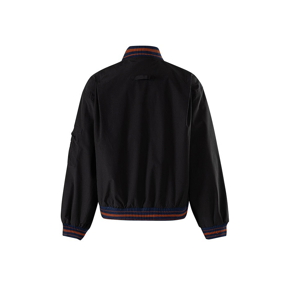 Back view of black bomber jacket with navy and orange striped ribbed collar, cuffs and hem and a small neck strap loop