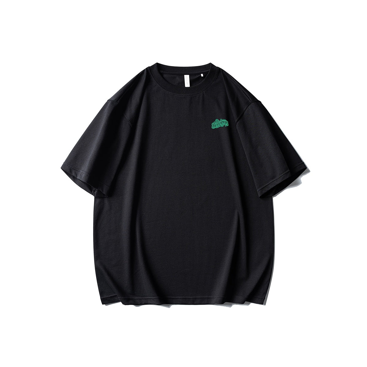 Front view of a black oversized T-shirt with a small green script logo on the chest.