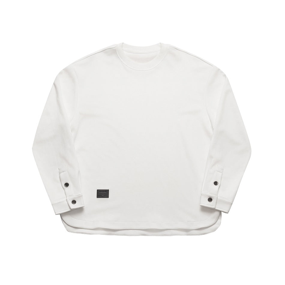 White long-sleeve crew-neck top, front flat lay, with button cuffs, curved hem and small dark label patch