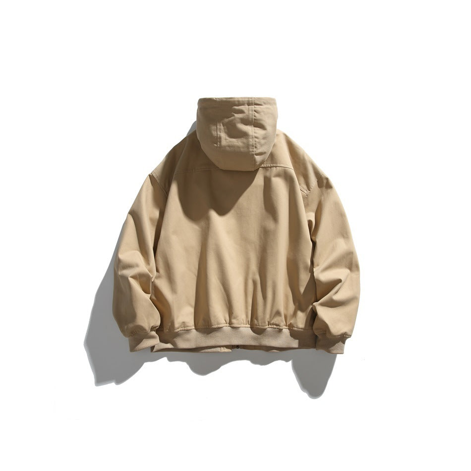 Back view of a tan hooded jacket laid flat, with a gathered hem and cuffs.