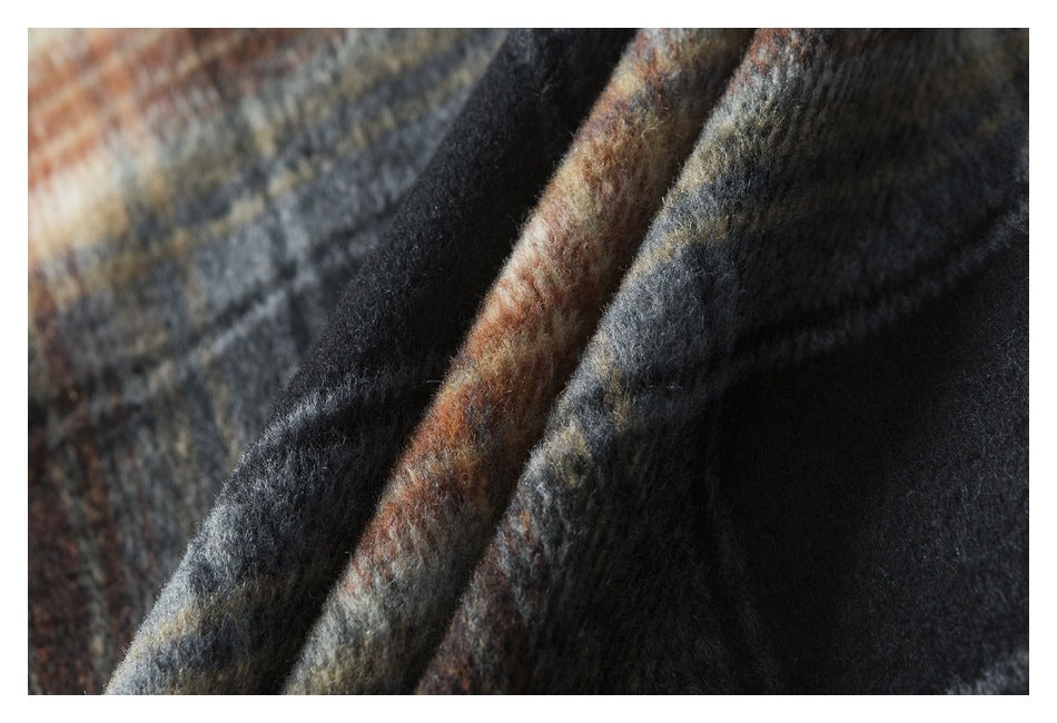 Extreme close-up showing the jacket's fuzzy dark plaid fabric in charcoal, gray, cream, and rust.