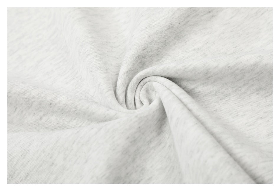 Close-up of light gray marled T-shirt fabric gathered into a soft twist.