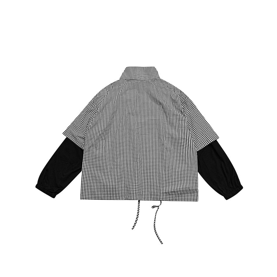 Back view of a black-and-white gingham jacket with long black sleeves, a high collar and dangling waist drawstrings.