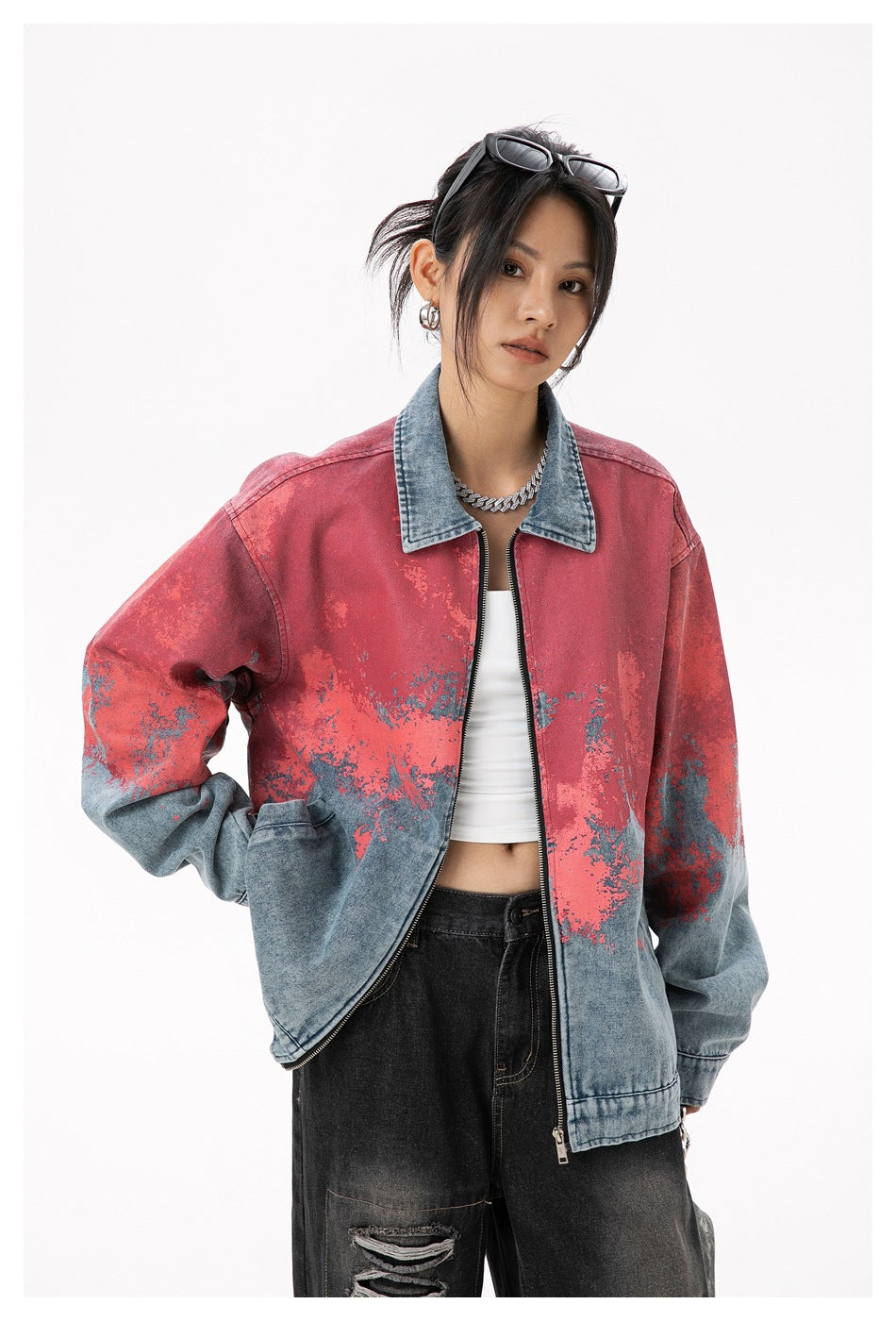 Model wearing a red and blue distressed denim zip jacket in a relaxed pose, showing its front and oversized fit.