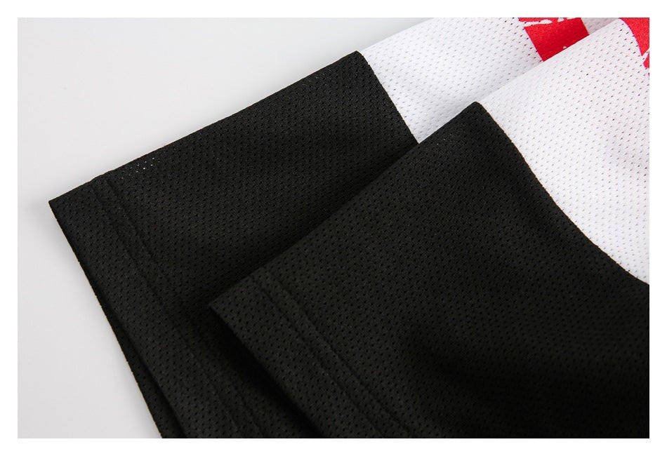 Close-up of black mesh garment panels beside a white mesh section with a small red accent.