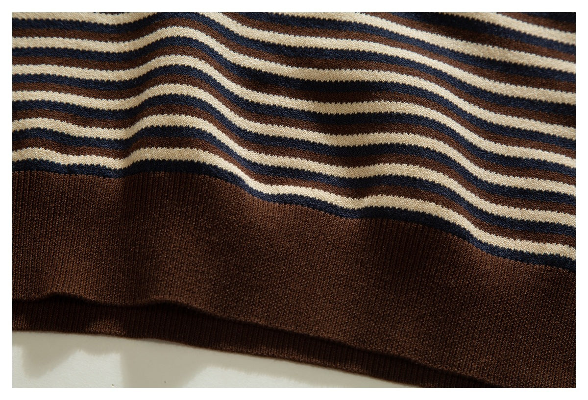 Close-up of a brown ribbed hem beneath wavy cream, navy, and brown stripes.