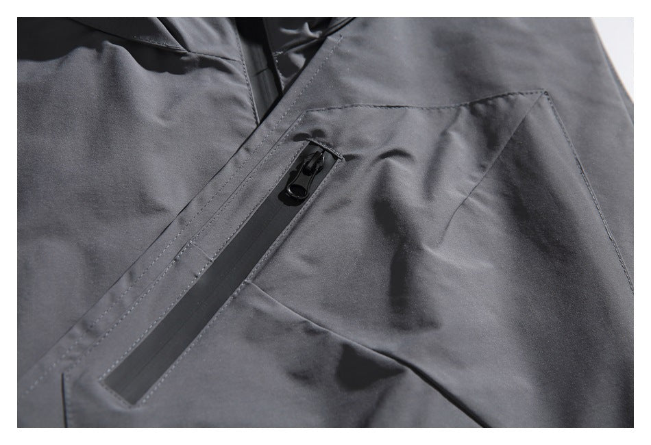 Close-up of a charcoal-gray angular front pocket with a long vertical zipper and black pull.