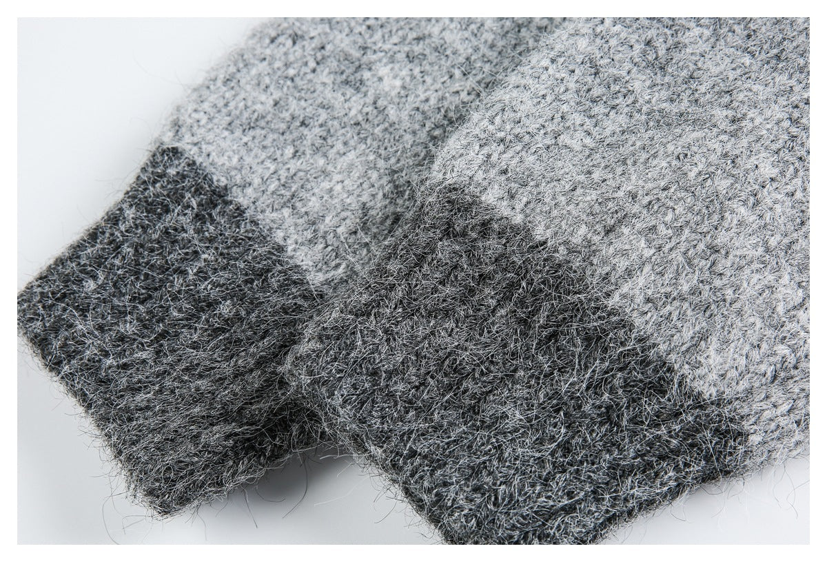 Close-up of overlapping light and dark gray marled knit fabric with a folded edge.