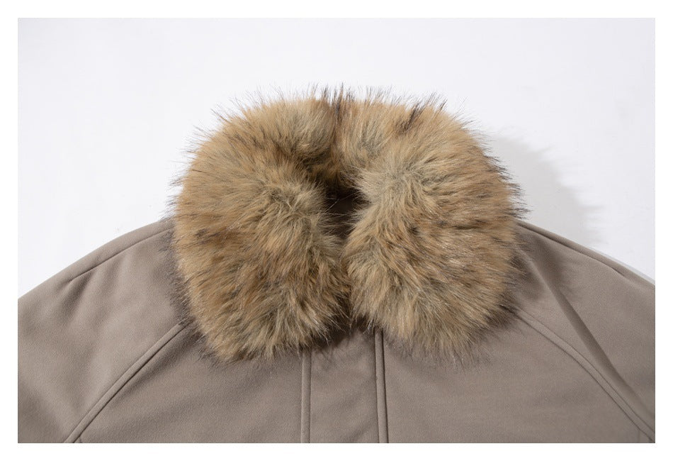 Close-up of a taupe jacket’s thick tan faux-fur collar and stitched neckline.