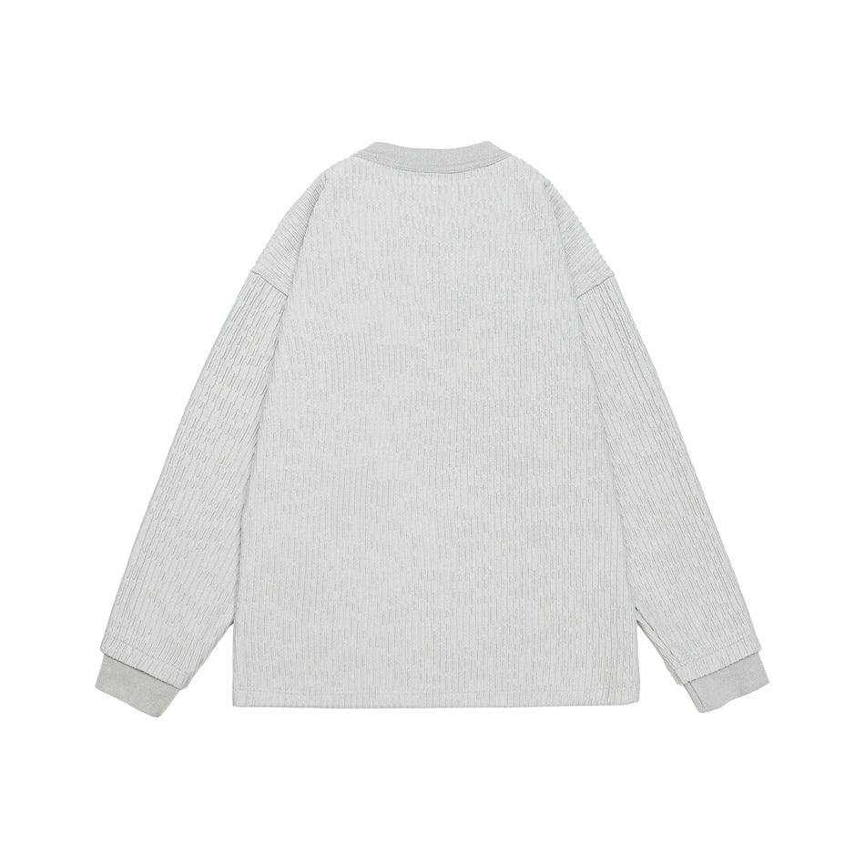 Back view of a light gray ribbed long-sleeve top with a round neckline and ribbed cuffs.