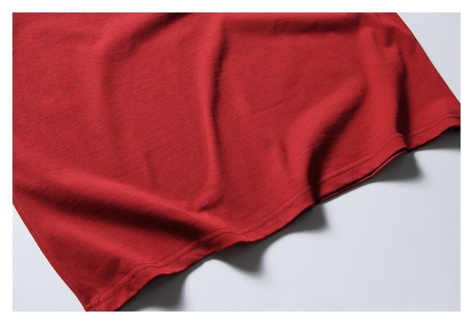 Close-up of the red shirt's lower edge and stitched hem.