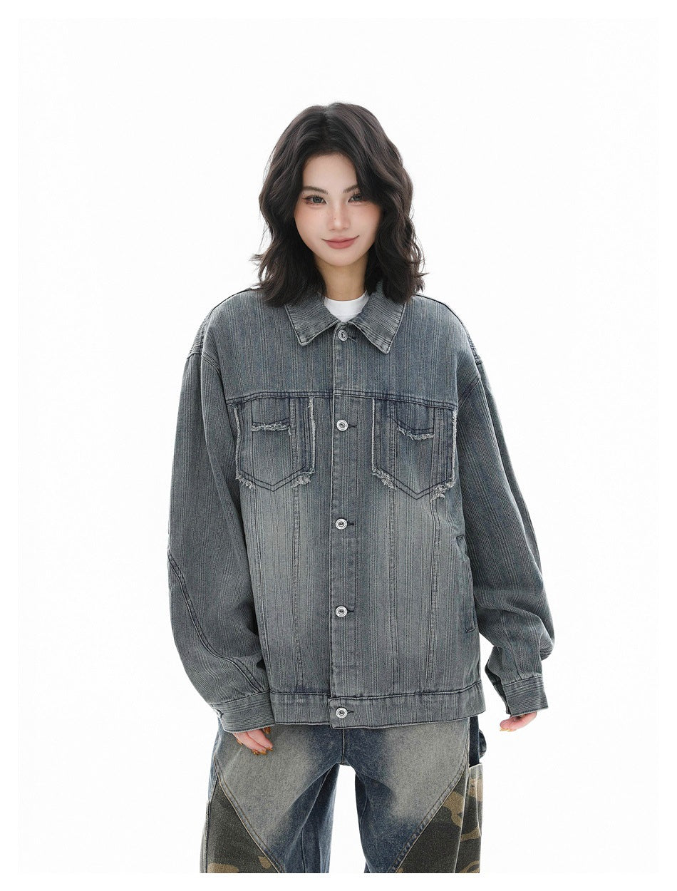 Model wearing a blue washed striped denim jacket buttoned over a white tee, with faded camouflage-panel jeans